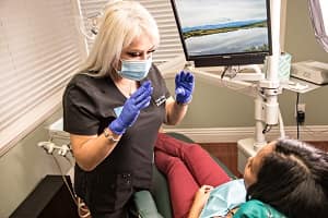 A patient talking to Erika at Glassell Dental